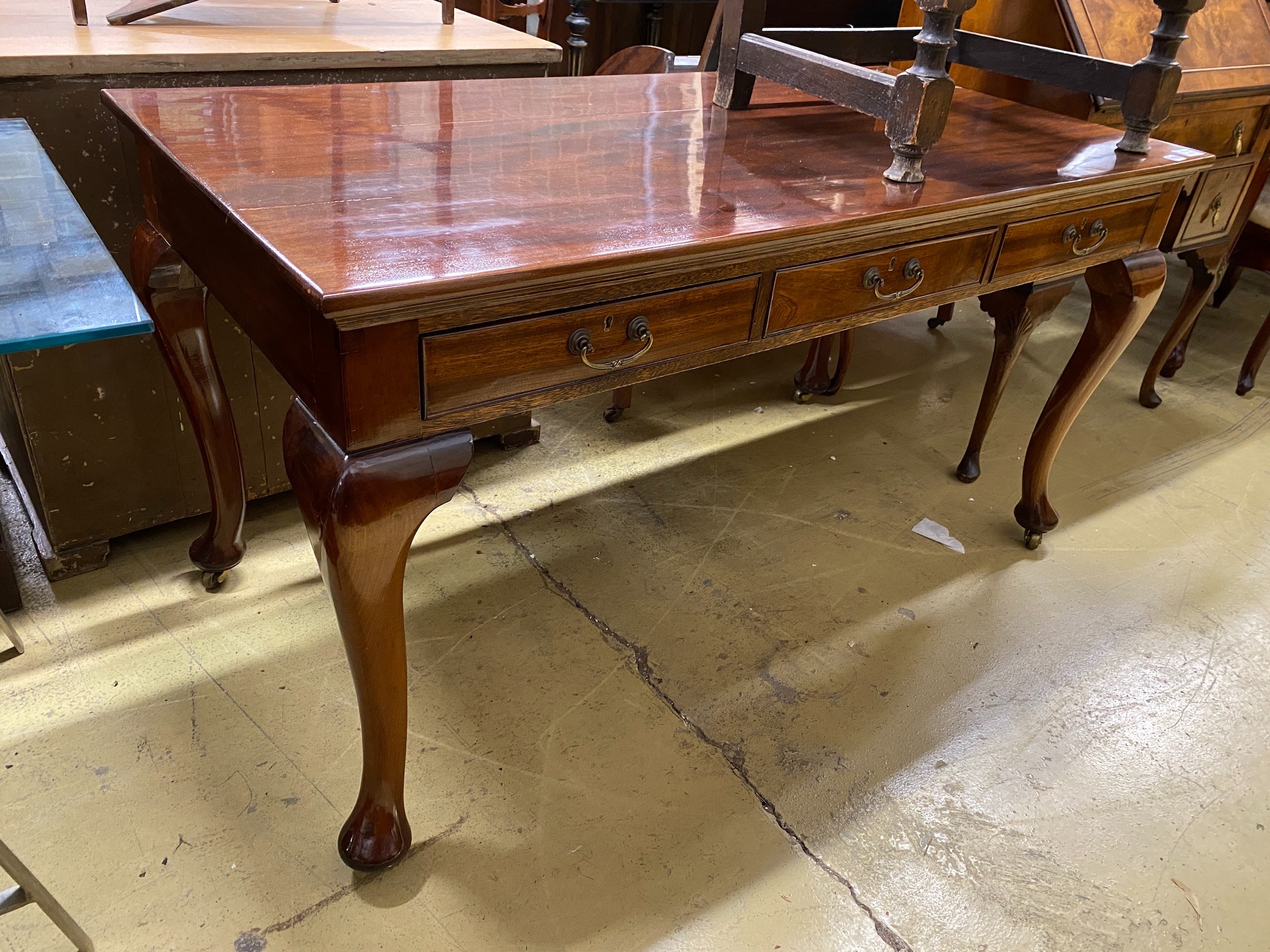 A reproduction Victorian style mahogany three drawer serving table, width 43cm, depth 70cm, height 75cm